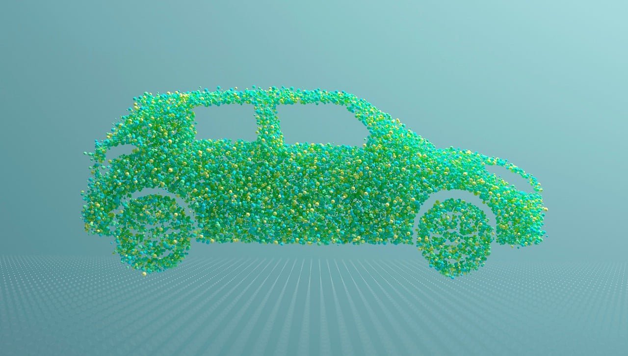 Ilustração de um carro visto de lado, formado por milhares de pequenas esferas verdes, azuis e amarelas, sobre fundo azul-esverdeado.